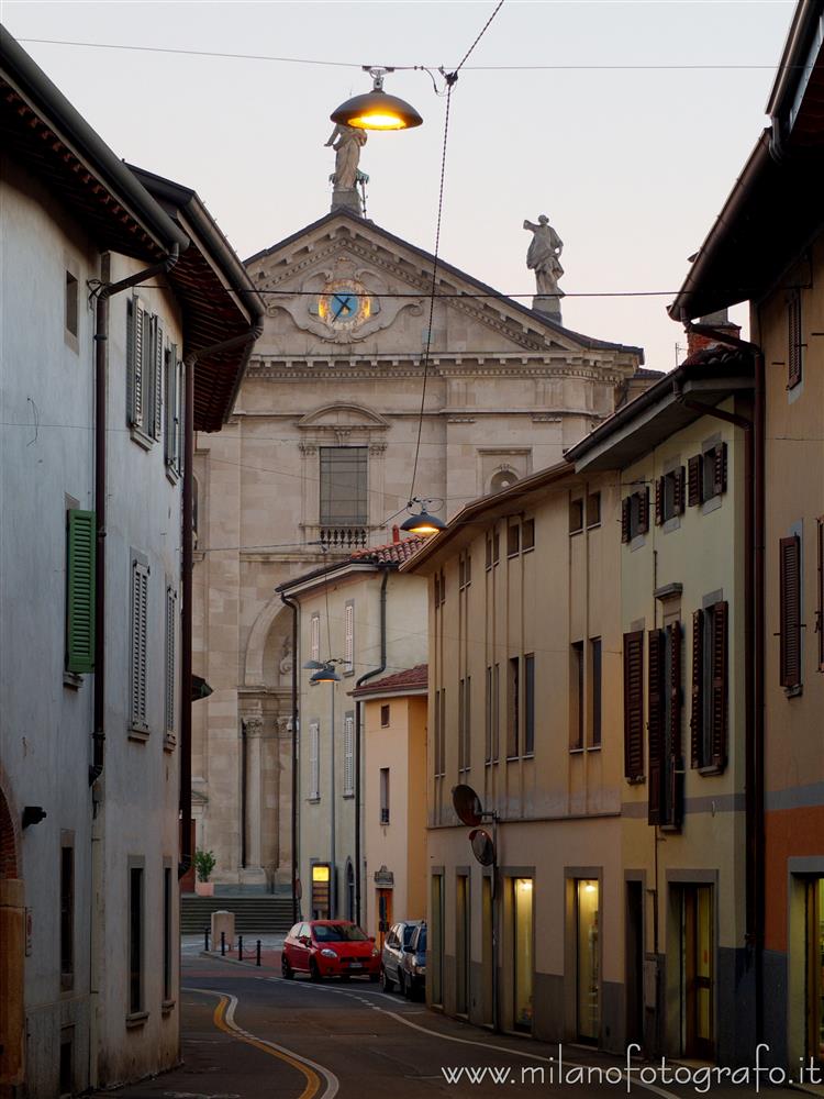 Urgnano (Bergamo, Italy) - The Church of Saints Nazario and Celso at the end of the street at dusk